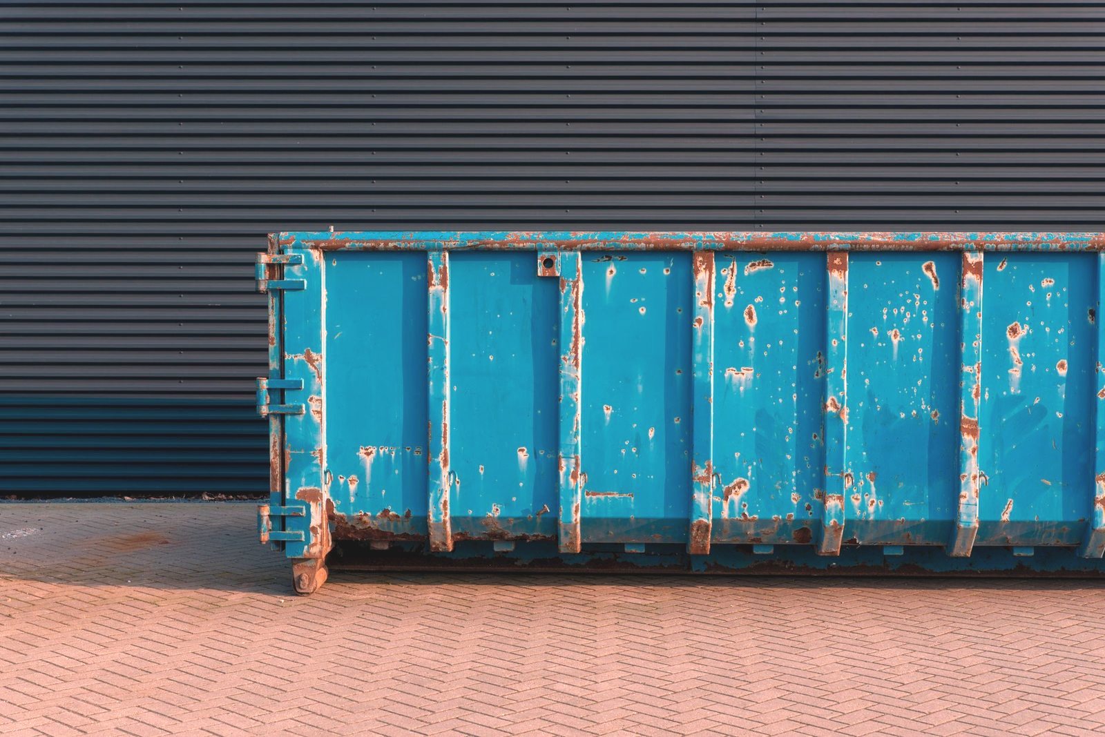 Roll-off container positioned for a roof tear-off